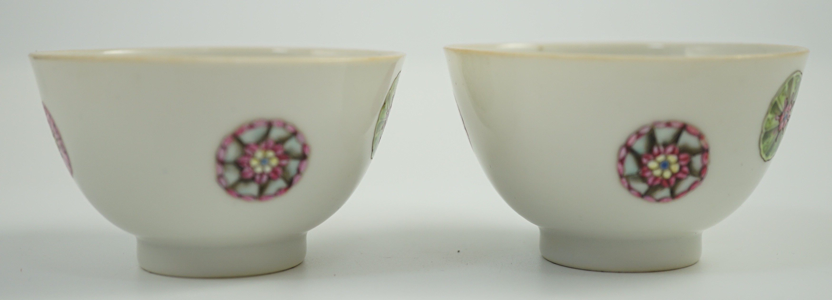 A pair of Chinese enamelled porcelain tea bowls, Qianlong seal marks, 7cms diameter